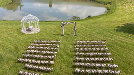 A wedding ceremony set up overlooking the water in a Niagara vineyard.