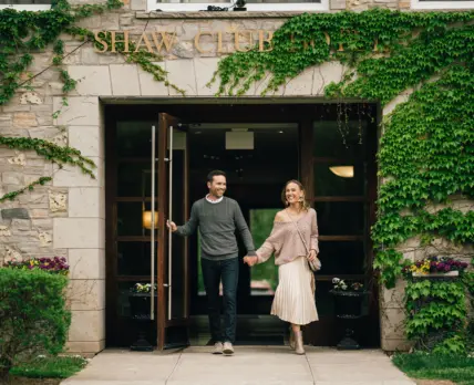 A couple walking out of The Shaw Club hotel in Niagara-on-the-Lake.