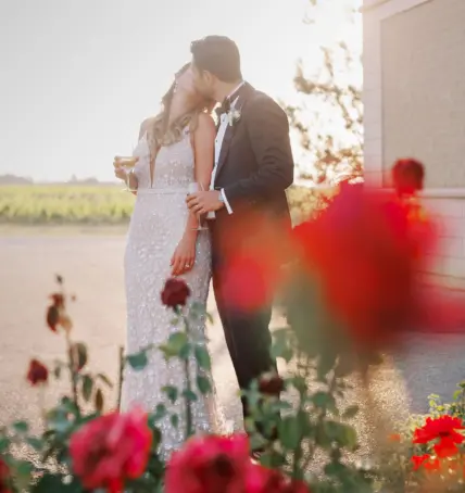 A newly married couple kissing outside of Château des Charmes in Niagara-on-the-Lake.