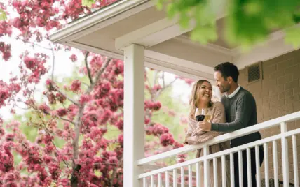 A couple standing on a hotel balcony in Niagara, Ontario.