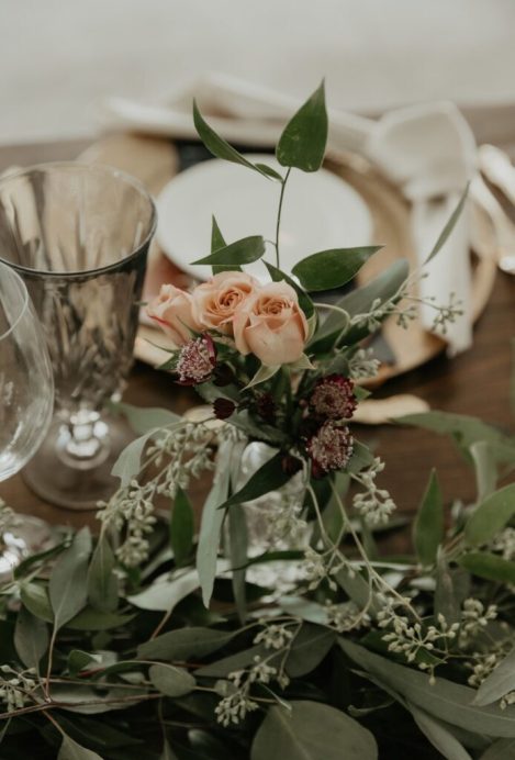 Boho floral centerpiece with greenery and burnt orange blooms for a wedding in Niagara-on-the-Lake at Bella Terra Vineyards